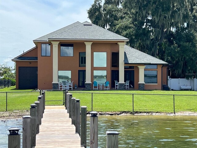 dock area featuring a yard and a water view