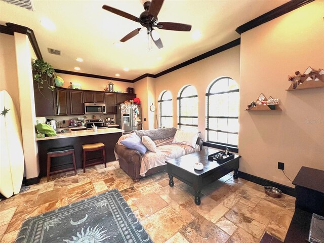 living room with ceiling fan, sink, crown molding, and light tile patterned floors