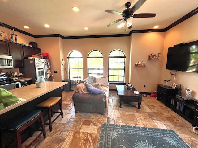 living area with baseboards, a ceiling fan, crown molding, stone tile flooring, and recessed lighting