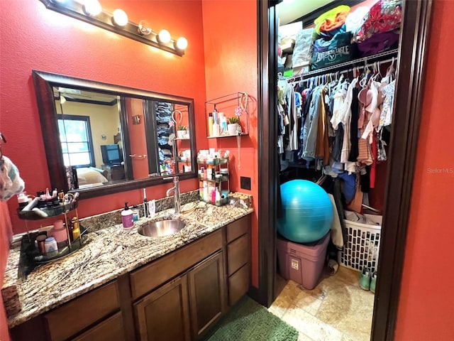 full bath with a spacious closet and vanity