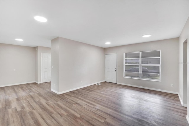 spare room featuring wood-type flooring