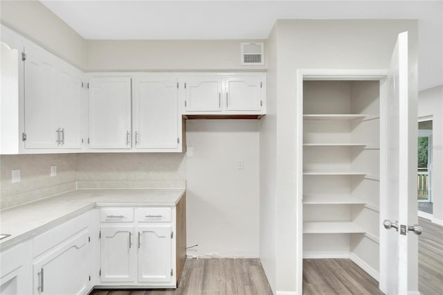 kitchen featuring white cabinets and light hardwood / wood-style floors