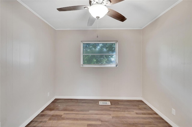 empty room with crown molding, hardwood / wood-style flooring, and ceiling fan