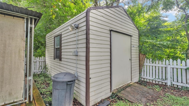 view of shed with fence