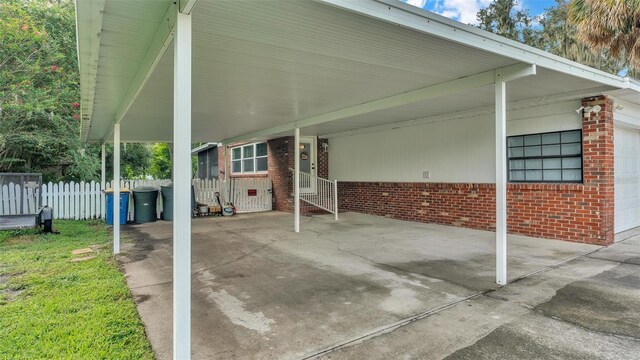 view of patio / terrace with a carport and fence