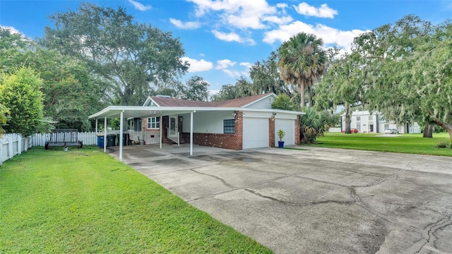 view of front of property featuring driveway, a garage, fence, a front yard, and brick siding