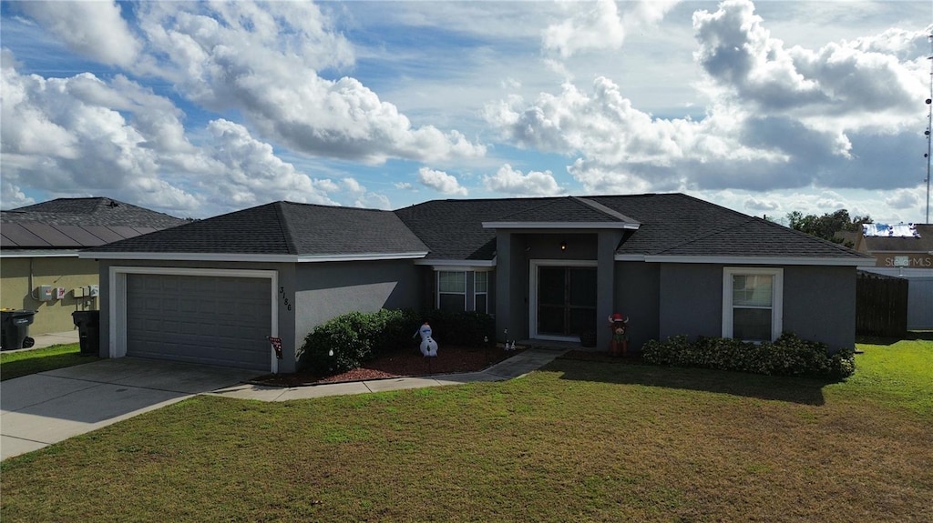 view of front of house featuring a front yard and a garage