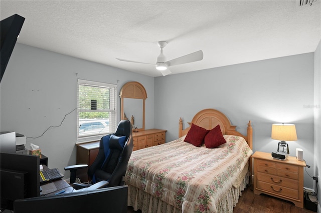 bedroom featuring a textured ceiling, ceiling fan, and dark wood-type flooring