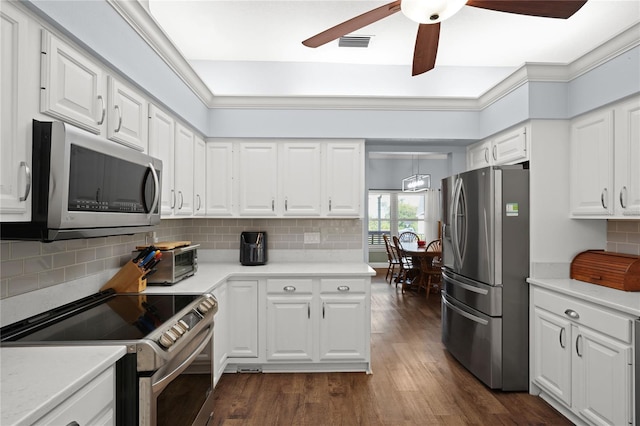 kitchen with appliances with stainless steel finishes, white cabinetry, and ceiling fan