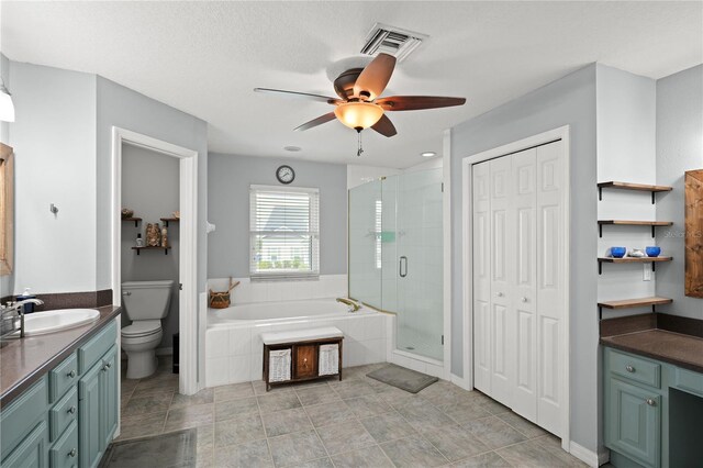 full bathroom with vanity, toilet, ceiling fan, and independent shower and bath