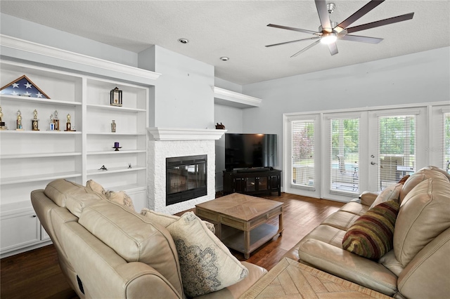 living room featuring french doors, a textured ceiling, dark hardwood / wood-style floors, and ceiling fan