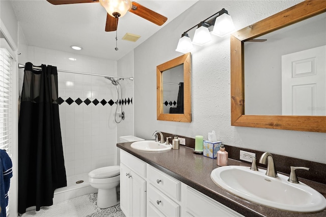 bathroom featuring ceiling fan, tile patterned flooring, toilet, vanity, and a shower with shower curtain