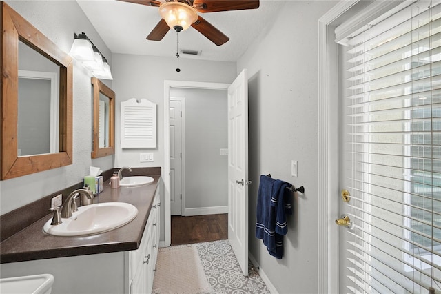 bathroom featuring ceiling fan, tile patterned flooring, vanity, and a textured ceiling