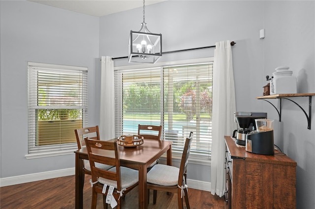 dining space featuring dark hardwood / wood-style flooring and a chandelier