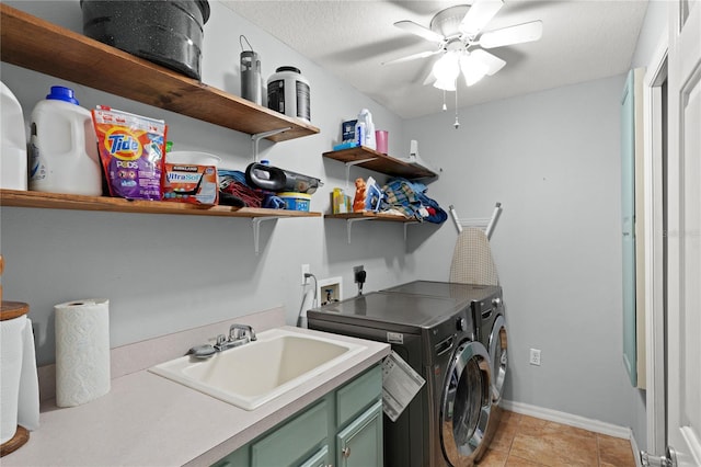 laundry area featuring cabinets, ceiling fan, sink, light tile patterned floors, and washing machine and dryer