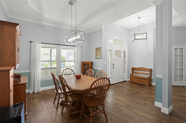 dining area featuring ornamental molding, dark wood-type flooring, and an inviting chandelier