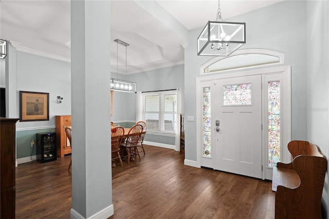 entryway featuring crown molding, dark hardwood / wood-style flooring, and a chandelier