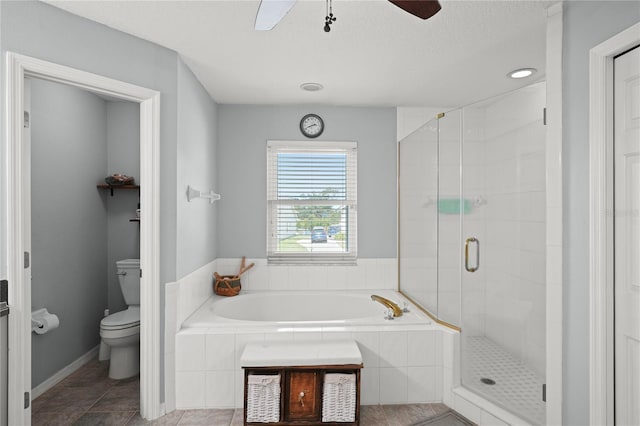 bathroom featuring tile patterned flooring, toilet, ceiling fan, and independent shower and bath