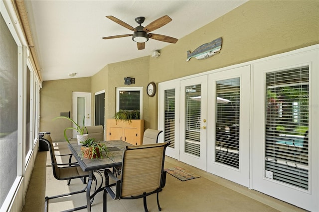 sunroom / solarium with ceiling fan, lofted ceiling, a wealth of natural light, and french doors