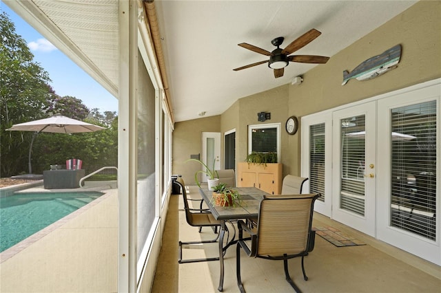 sunroom featuring ceiling fan, lofted ceiling, and french doors