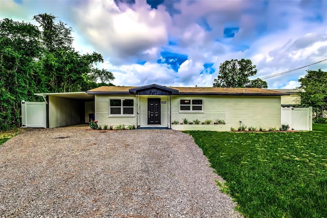 ranch-style home with a front lawn and a carport