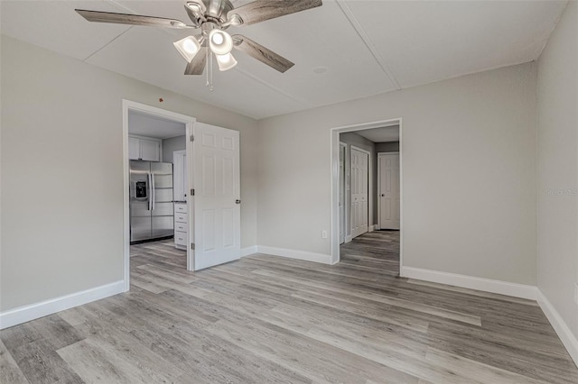 spare room with ceiling fan and light hardwood / wood-style flooring