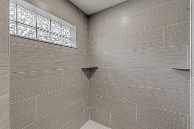 bathroom with a tile shower