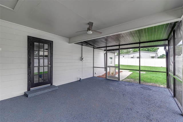 unfurnished sunroom with ceiling fan