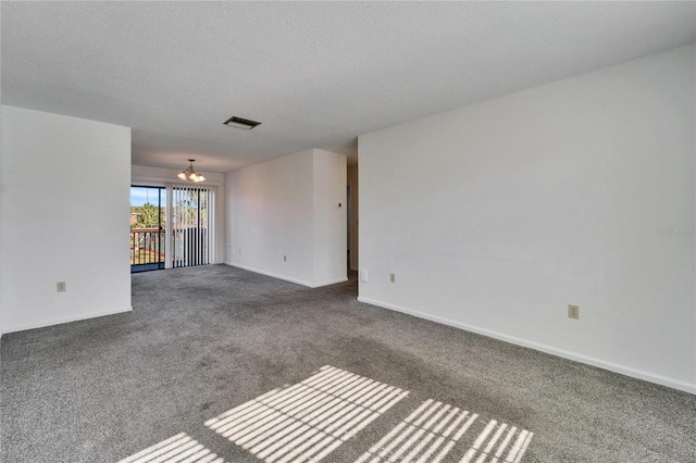 unfurnished living room with carpet floors, a chandelier, and a textured ceiling