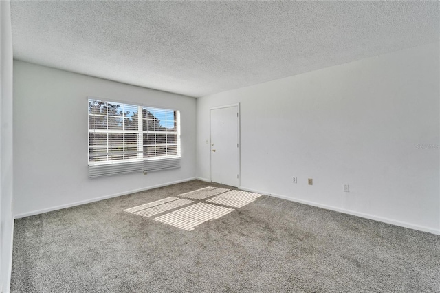 unfurnished room with carpet floors and a textured ceiling