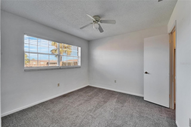 carpeted empty room featuring ceiling fan and a textured ceiling