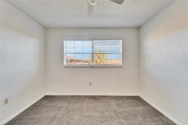 carpeted spare room with a textured ceiling and ceiling fan