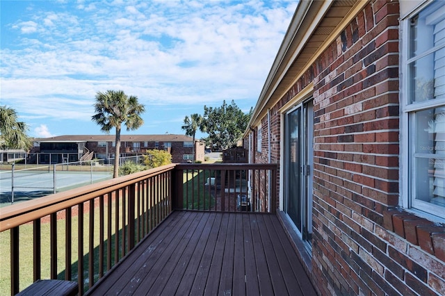 wooden deck featuring tennis court