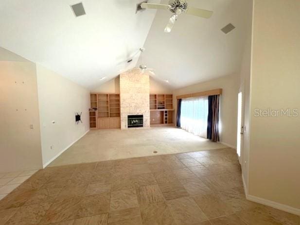 unfurnished living room featuring a stone fireplace, built in shelves, lofted ceiling, and ceiling fan