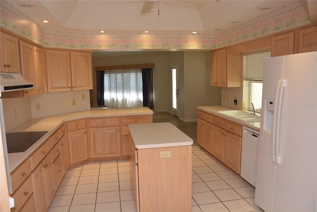 kitchen with light brown cabinetry, white appliances, a center island, and sink