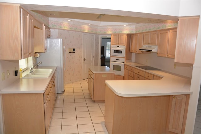 kitchen with white oven, black electric stovetop, light brown cabinets, and a center island