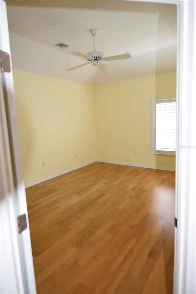 unfurnished room featuring ceiling fan and light wood-type flooring