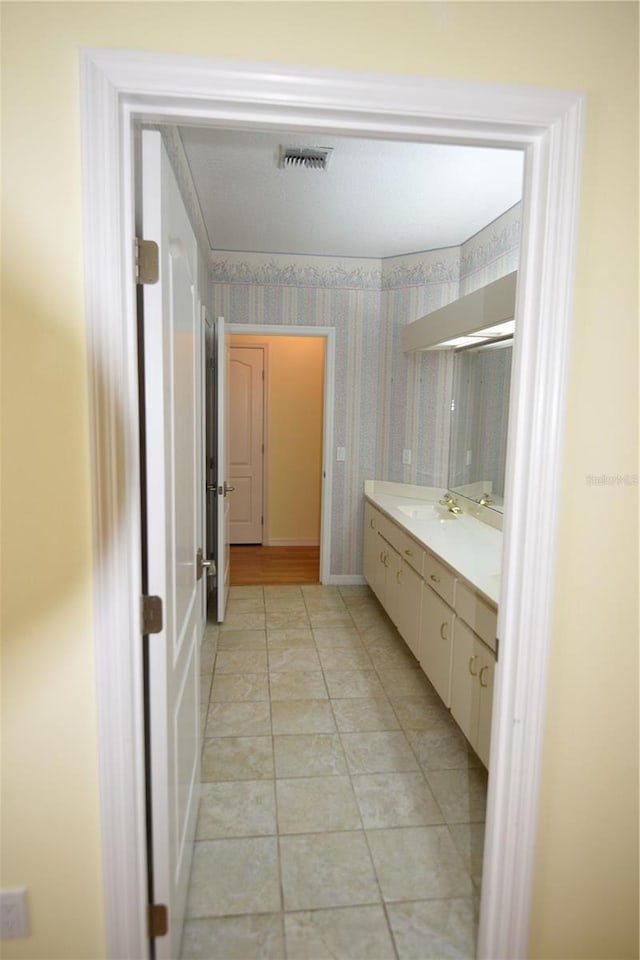 bathroom featuring vanity, tile patterned flooring, and a shower with door