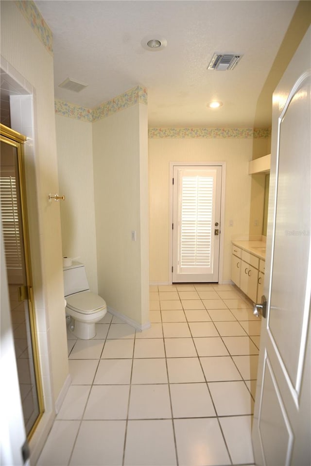 bathroom with vanity, toilet, and tile patterned floors