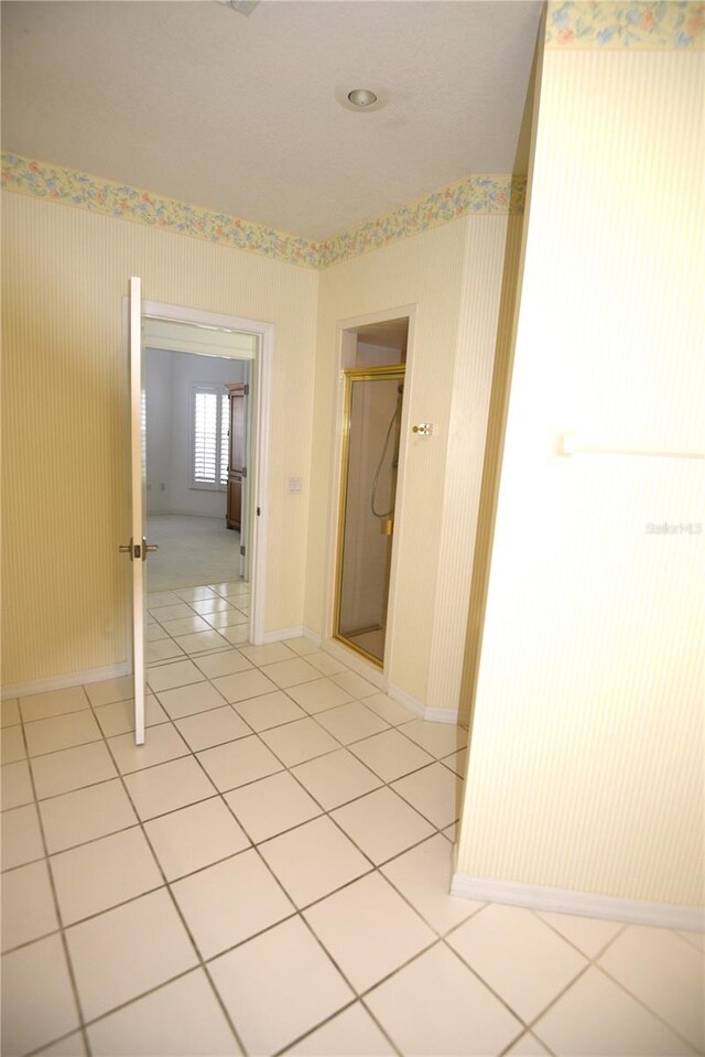 corridor featuring light tile patterned floors