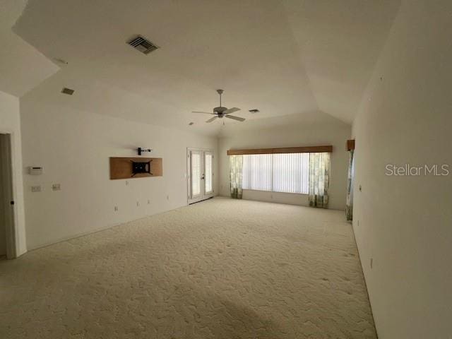 carpeted empty room featuring lofted ceiling and ceiling fan