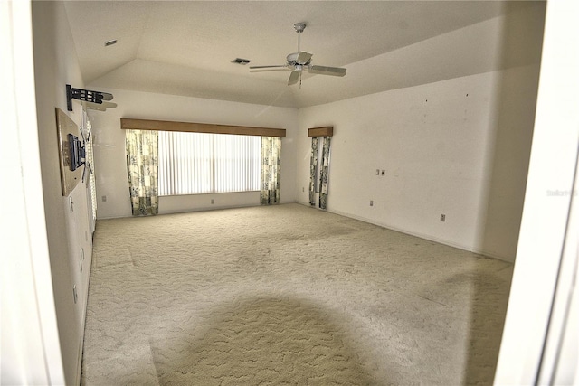 carpeted empty room featuring vaulted ceiling and ceiling fan