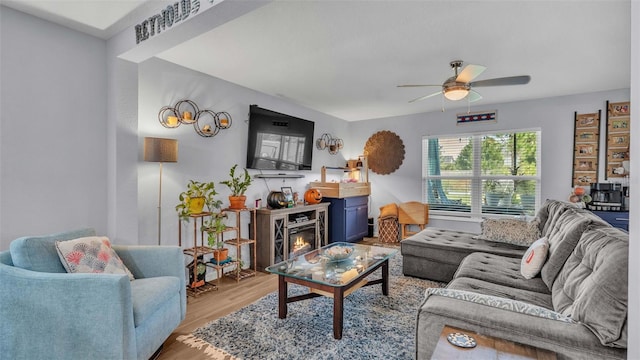 living room featuring light hardwood / wood-style floors and ceiling fan