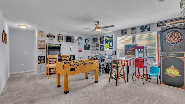 game room featuring ceiling fan, light colored carpet, and a textured ceiling