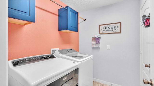 laundry area featuring cabinets, independent washer and dryer, and a textured ceiling