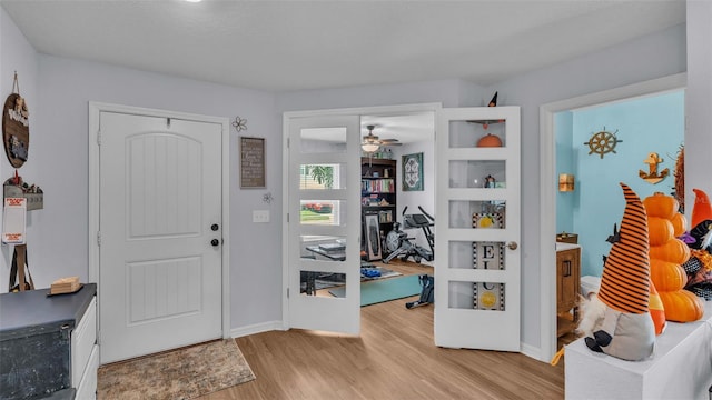 foyer featuring ceiling fan and light wood-type flooring