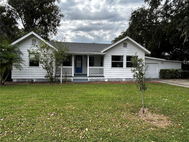 ranch-style house with a garage, a porch, and a front lawn