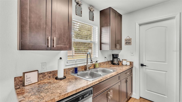 kitchen featuring sink, dark brown cabinetry, dishwasher, and light hardwood / wood-style floors