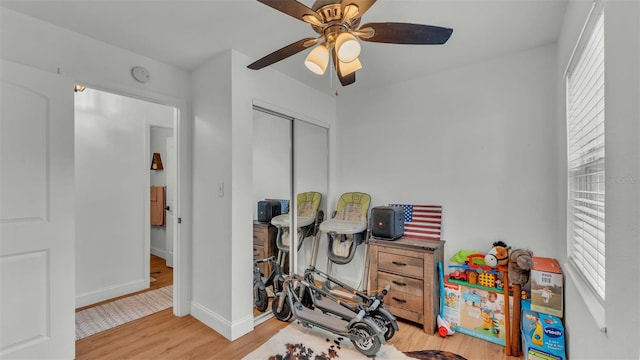 rec room with light hardwood / wood-style flooring and ceiling fan