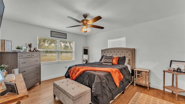 bedroom with light hardwood / wood-style flooring and ceiling fan